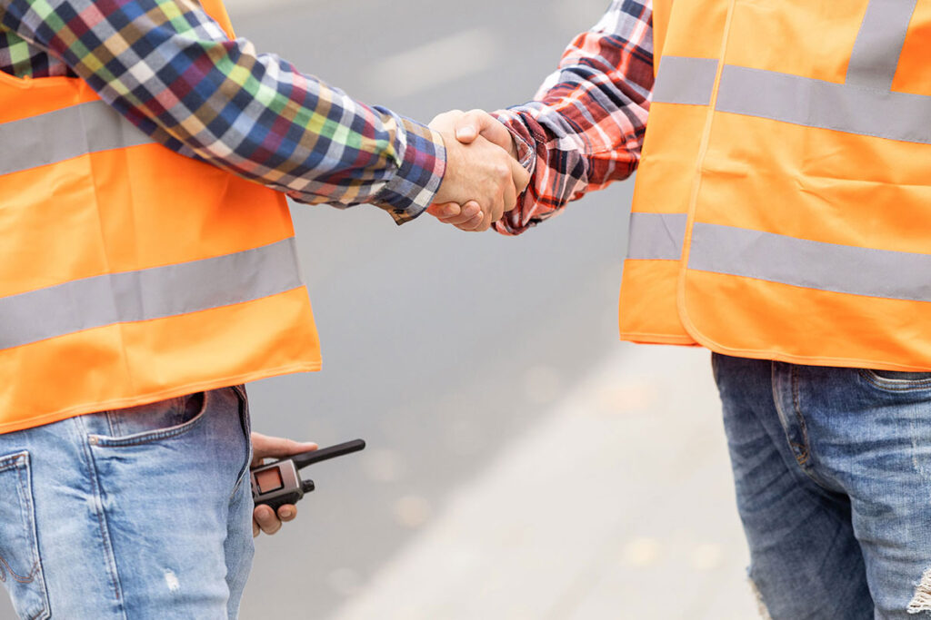 Construction workers shaking hands